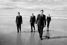 Groomsmen enjoying the sand between their toes