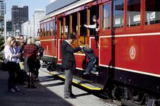 Father helping son out of the Tram