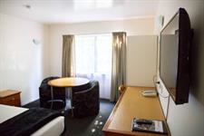 Desk and Flat Screen TV in Deluxe Studio
