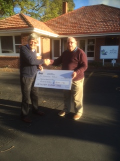 Nicholas Wynne, Lions of Bethlehem Te Puna (right), presents Barry Davies, Te Whanau Kotahi with the cheque